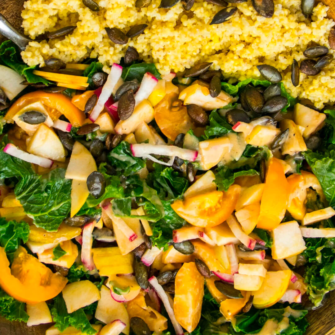 A close up of a bowl of food containing veggies and fruits and cereals